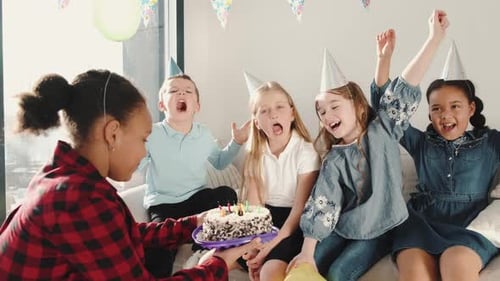 Excited Children Celebrating Birthday with Cake and Friends