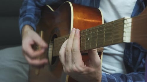 Man playing ballad song on acoustic guitar. Music concept