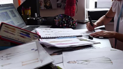 Fashion Designer Sketching at Desk Indoors