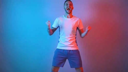 Enthusiastic Soccer Fan Celebrating Goal Raising Arms Fan, Support Concept Studio Shot