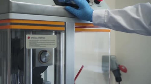 Worker Watching Pill Press Machine at the Pharmaceutical Factory Laboratory Spbd