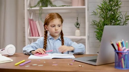 Red Haired Girl Learning at Desk with Laptop