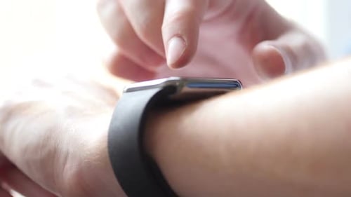 Person Taps Smartwatch in Close Up Shot