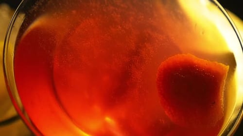 Top Angled View of a Red Cocktail and Party Lights Reflecting on It