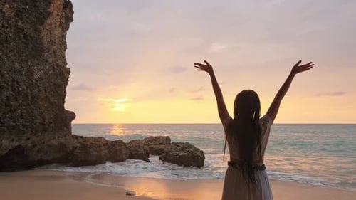 Happy Woman Stand on Sand of the Sea and Show Hand in To Sky. Subject Is Blurred. Woman Expressing