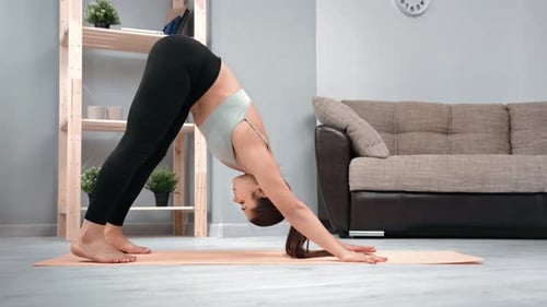 Woman Does Yoga in Home Living Room
