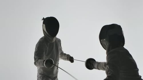Two Fencers Strike Each Other with Swords. Duel Between Two Competitors. Dark Silhouettes on a White