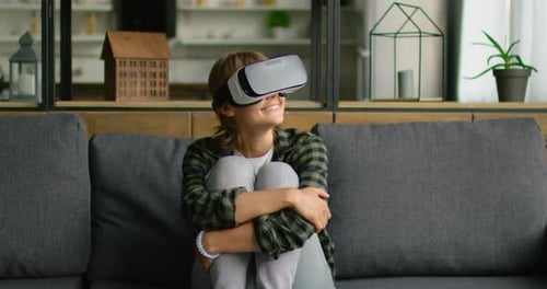 Young Woman Wearing VR Headset at Home