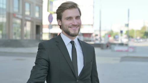 Man in Suit Gives Okay Hand Gesture