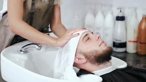 Man Relaxing While Hair is Dried at Salon