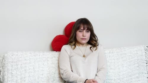 Brunette Sitting on Couch Alone