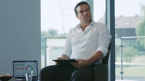 Business Man Sitting with Notebook. Professional Working with Chart Documents