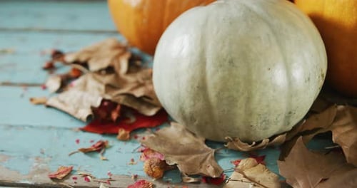Pumpkins and Autumn Leaves on Antique Table