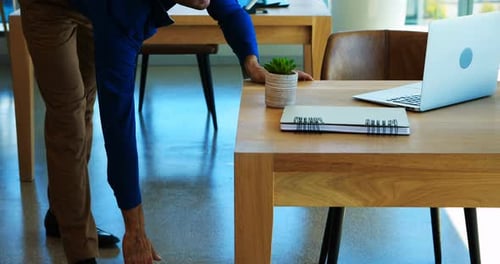 Adult Man Stretching in Modern Office Environment