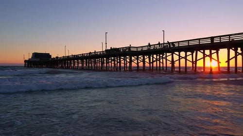Waves rolling on the beach during sunset at Newport Beach