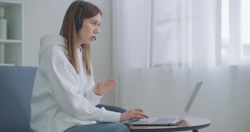 Woman Works at Home on Laptop Video Call