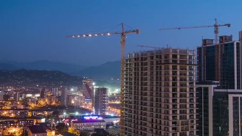 Building Construction From Day To Night, Timelapse, Tower Crane with Lighting on a Construction Site