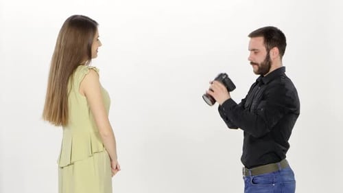Model and Photographer. Photoshoot in the Studio in Profile. White