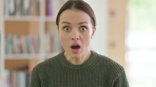 Woman Gasps and Covers Mouth in Surprise