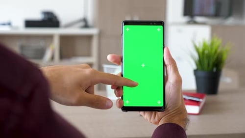 Man Hand Scrolling Down on a Smartphone with Green Screen Chroma Mock Up