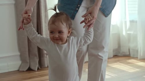 Happy Baby Taking First Steps Indoors