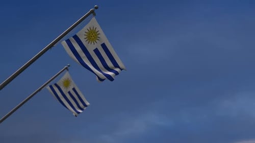 Waving Flag of Uruguay Against Blue Sky