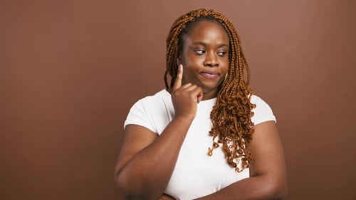 Thoughtful African American Lady Got Great Idea Raising Finger Up with Inspiration Brown Studio
