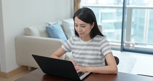 Woman Using Laptop in Modern Apartment