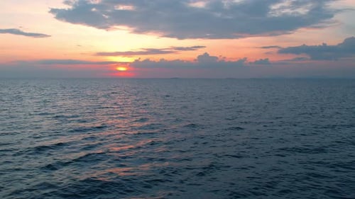 4K aerial view from a drone, slow motion waves in the orange sea