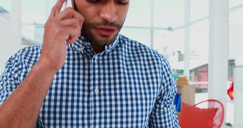 Man Talking on Smartphone in Bright Modern Office