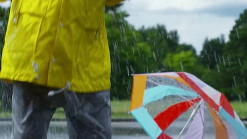 Little Boy Playing in Puddle