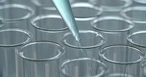 Clear Liquid Dripping into Test Tubes in Laboratory