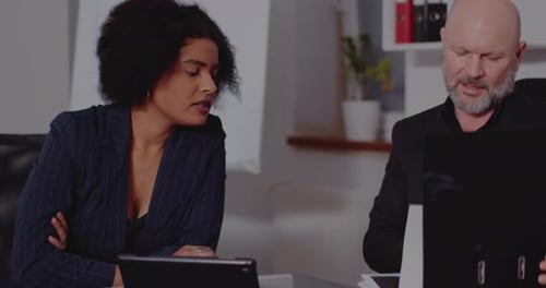 Colleagues Working on Documents in the Office