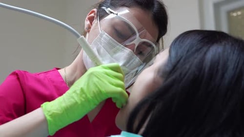Dentist Working on Patient in Clinical Setting
