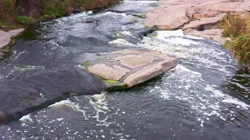 A Fast Stream Among Smooth Dark and Wet Stones