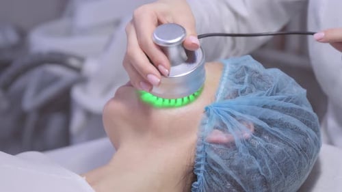 Woman Receiving Facial Treatment with Electronic Device