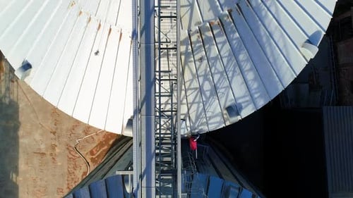 Aerial View of Gleaming Grain Silos on Farm