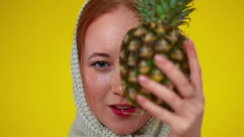 Closeup Headshot or Beautiful Redhead Young Woman with Green Eyes Closing Half of Face with