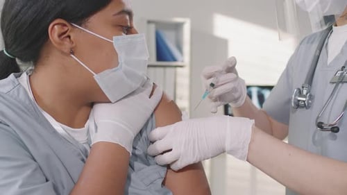 Adult Getting Vaccine in Medical Clinic