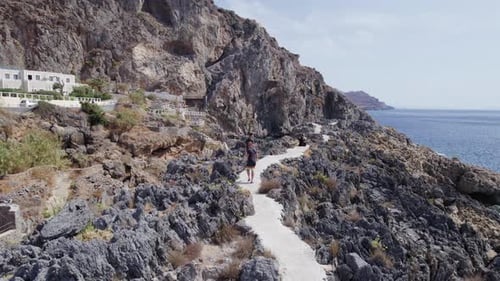 Drone footage of people walk in the Kalypso wild beach, Cretan village blue logons, coral reefs