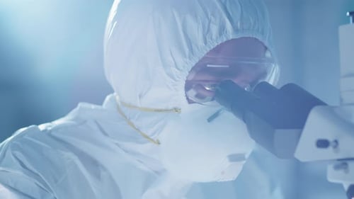 Scientist Using Microscope in Lab