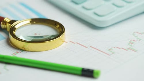 Documents with Magnifying Glass and Calculator