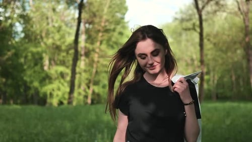 A Young Girl Model Walks Through the Forest