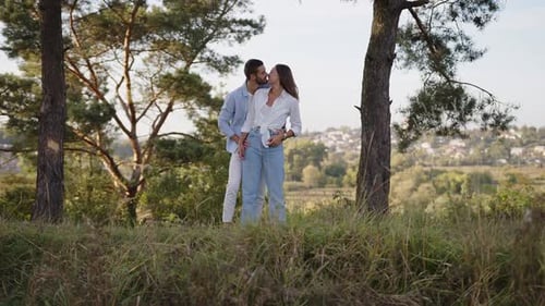 A Beautiful Girl and Boy Hugging in a Park