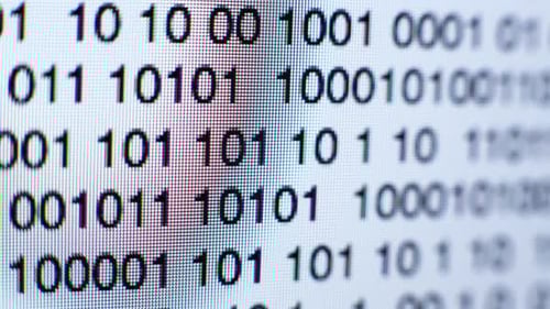 Binary Code Scrolling on Screen Extreme Close Up