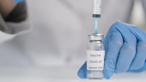Drawing COVID-19 Vaccine from Vial with Needle
