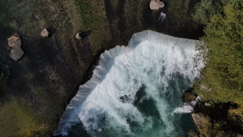 Fast Rising Drone Image Over Waterfall