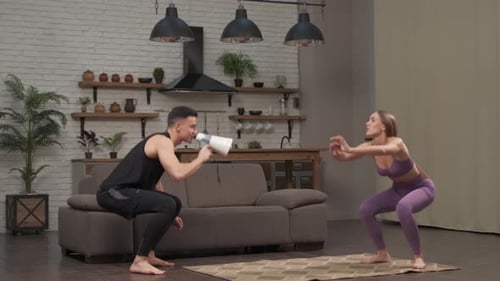 Man Shouts Workout Instructions to Woman With Megaphone