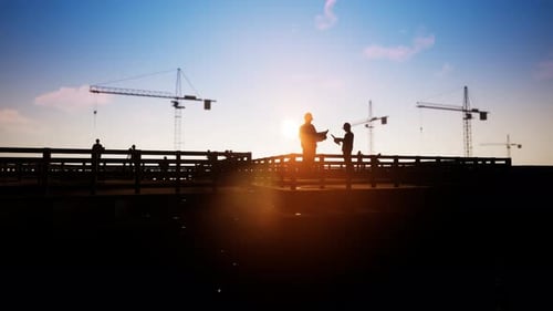 Engineers Discussing Plans on Construction Site at Sunset with Airplane