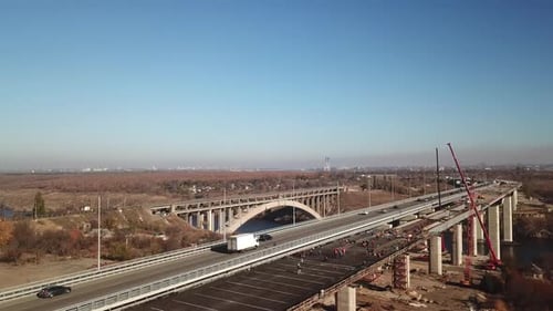 The bridge over the river. Car traffic on the bridge. View from the top. Drone aerial